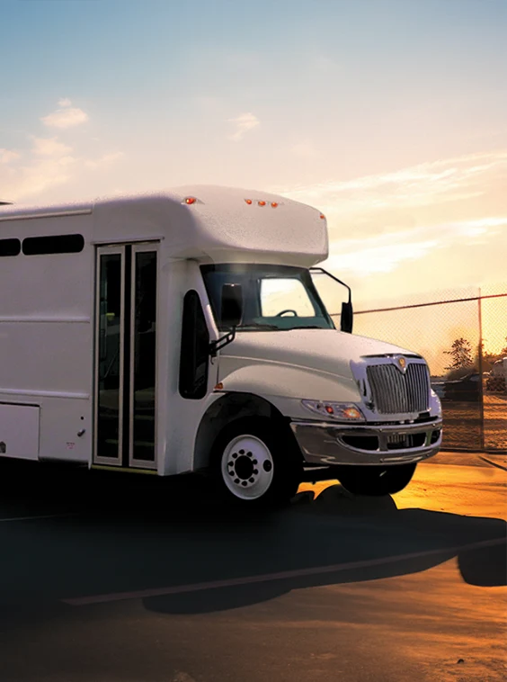 White shuttle bus parked next to a security fence at a prison near Seattle