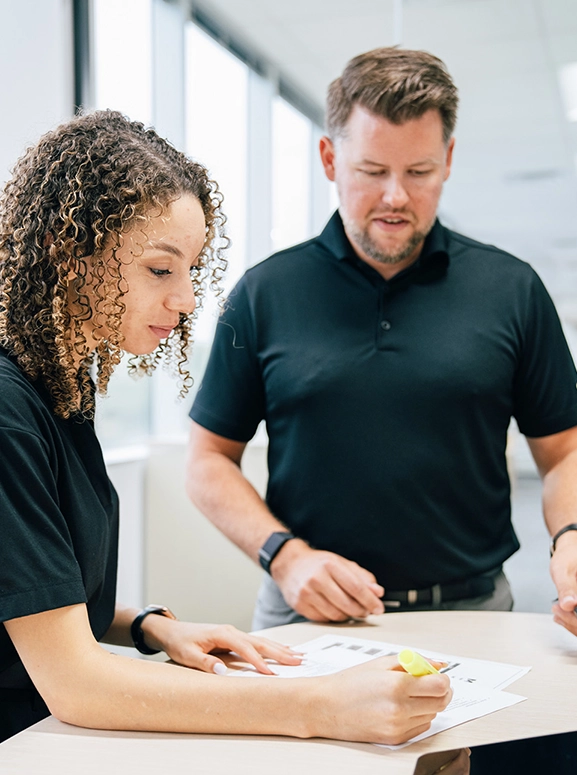 woman and man looking at forms for renting a vehicle in Seattle